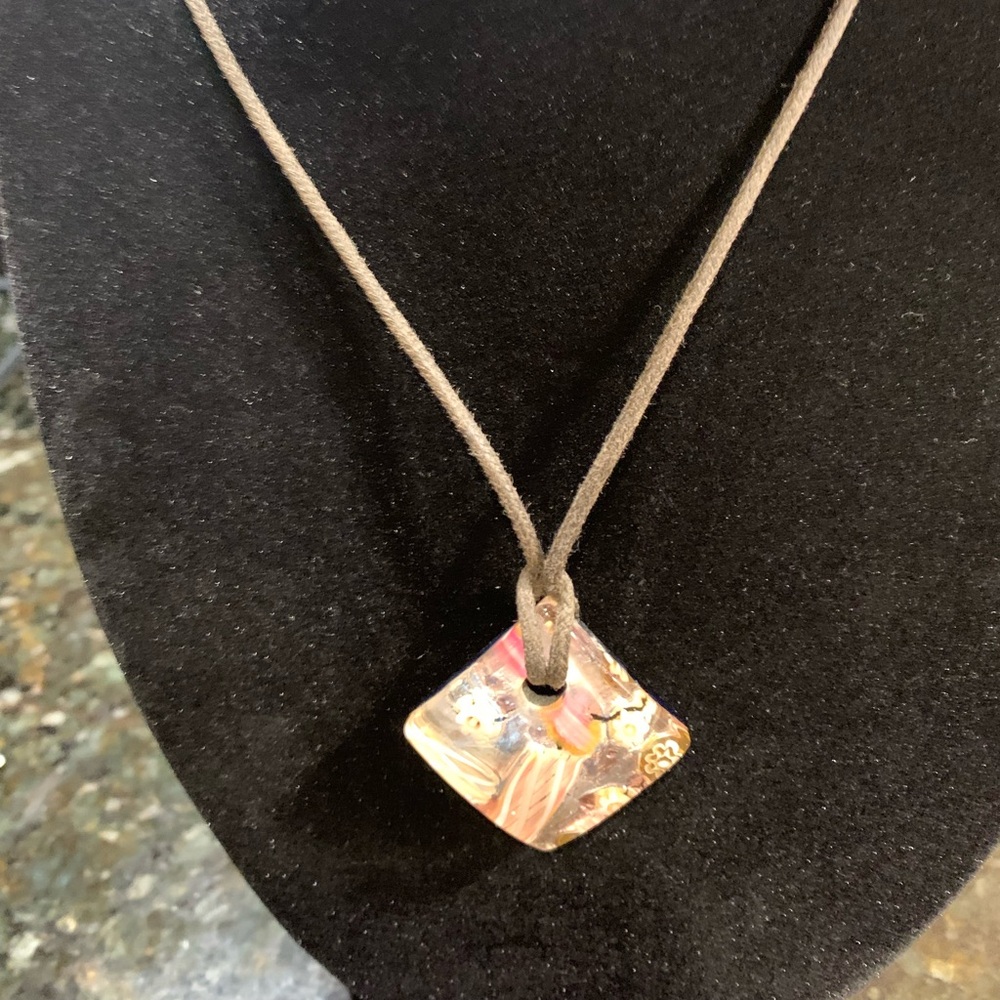 Glass pendant on 10 1/2” brown cord